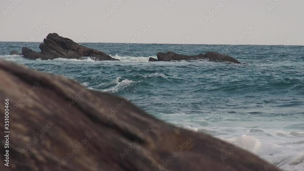 Small ocean waves hit the coastal rocks Small ocean waves hit the coastal rocks