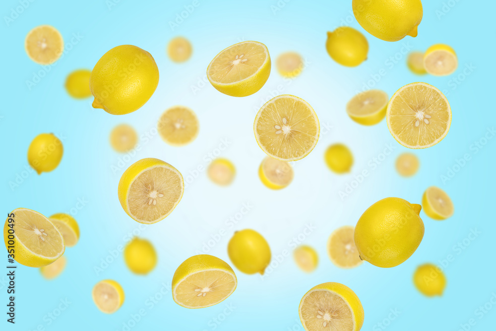 Falling lemons isolated on a blue background with clipping path as package design element and advertising. Flying food