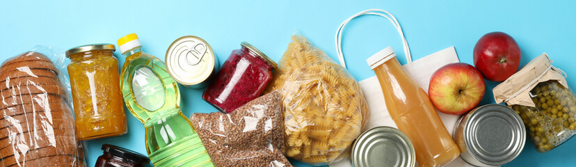 Different food on blue background, top view. Donation concept