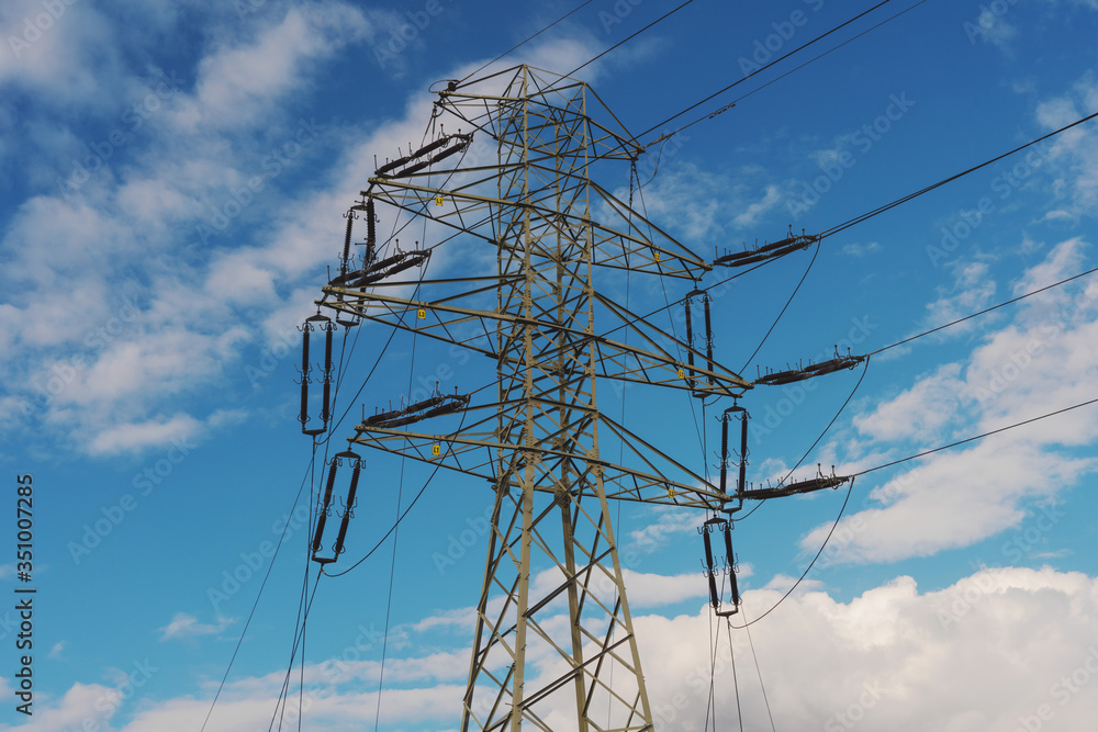 View of a power plant with many power lines on a background of beautiful cloudy sky View of a power plant with many power lines on a background of beautiful cloudy sky