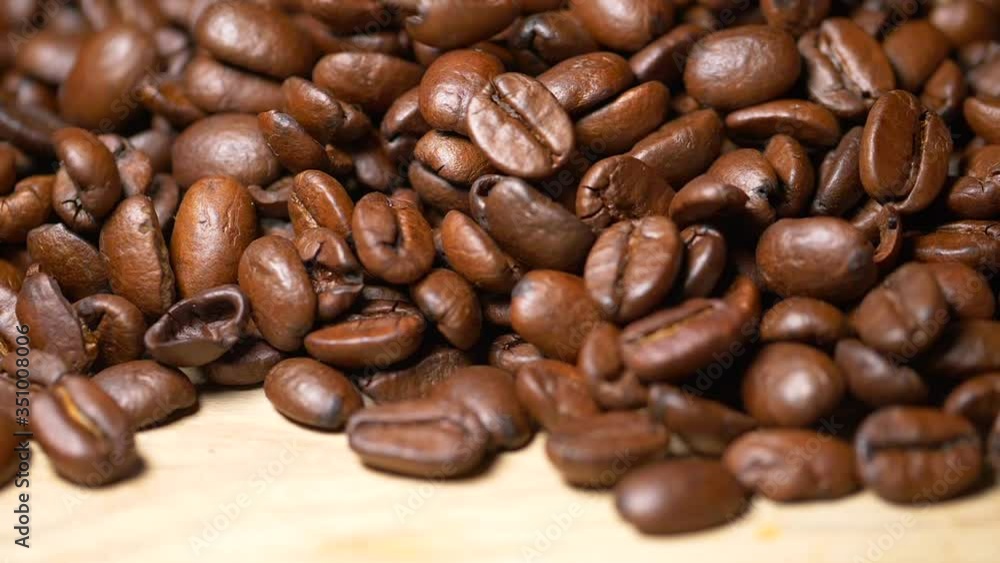 Close up shot of falling coffee bean grains in slow motion,professional studio footage Close up shot of falling coffee bean grains in slow motion,professional studio footage