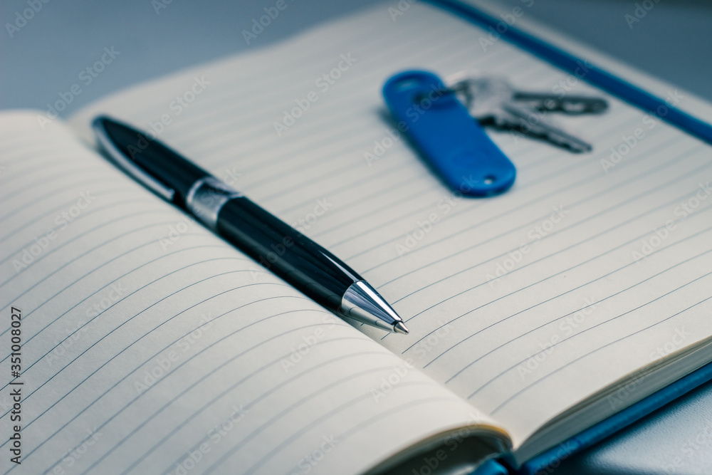 dark pen and key on the notepad dark pen and key on the notepad