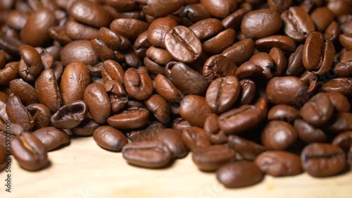 Close up shot of falling coffee bean grains in slow motion,professional studio footage photo