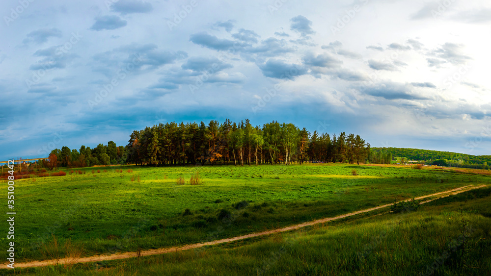 Obraz premium View from the hill to the sunset valley, panorama of village motifs, nature of the country