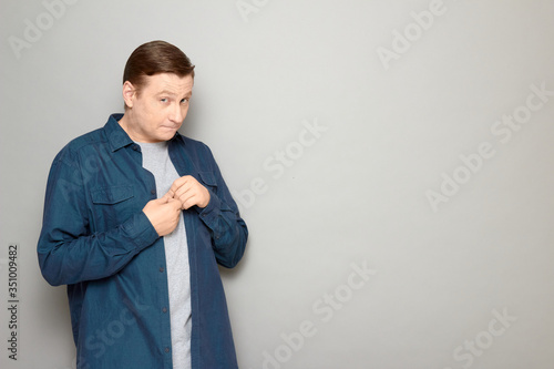 Portrait of shy mature man looking naive and timid feeling guilty