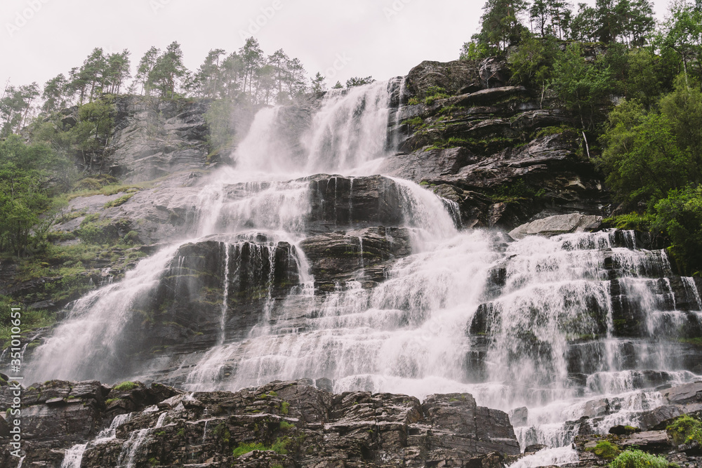 view of Tvindefossen or Tvinnefossen waterfall near Voss, Norway. Natural, landscape. Tvinde Camping. Marquee, rocks view of Tvindefossen or Tvinnefossen waterfall near Voss, Norway. Natural, landscape. Tvinde Camping. Marquee, rocks