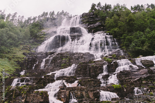 view of Tvindefossen or Tvinnefossen waterfall near Voss, Norway. Natural, landscape. Tvinde Camping. Marquee, rocks