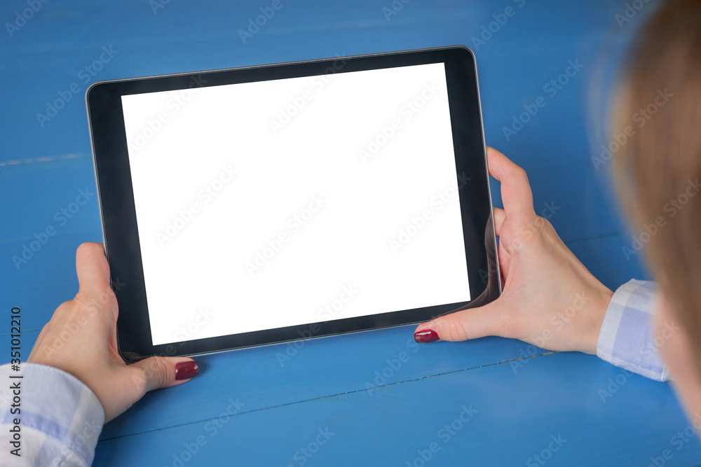 Mockup image: woman sitting and looking at black digital tablet computer device with white blank screen. Mock up, entertainment, copyspace, template, leisure time and technology concept Mockup image: woman sitting and looking at black digital tablet computer device with white blank screen. Mock up, entertainment, copyspace, template, leisure time and technology concept