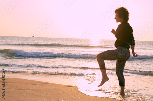 Athletic young caucasian girl jogging on the beach one sunny morning.  © Marina