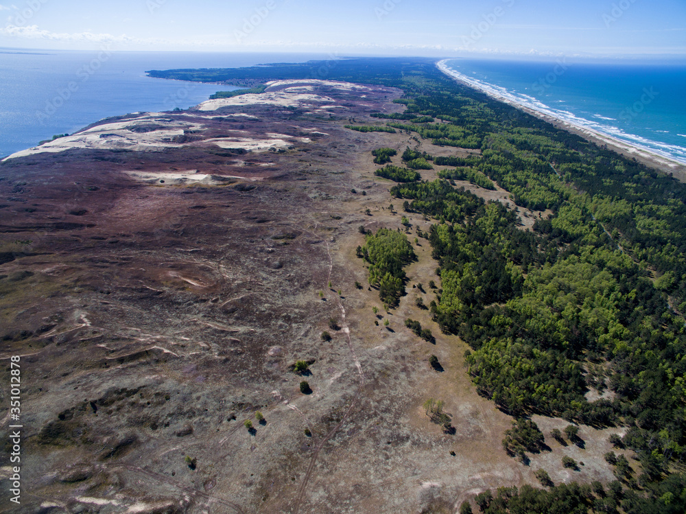 Aerial view with dunes, forest and sea in Curonian spit on a sunny day photographed with a drone. The Curonian Spit lagoon. Gray Dunes, Dead Dunes. Nida, Neringa, Juodkrante, Preila, Pervalka