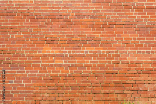 Red brick wall made of clay stones
