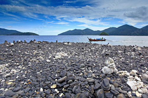 Ko Hin Ngam or Koh Hin Ngam is small island on the south of Adang island. The island is full of black shiny rocks  south of Adang island photo