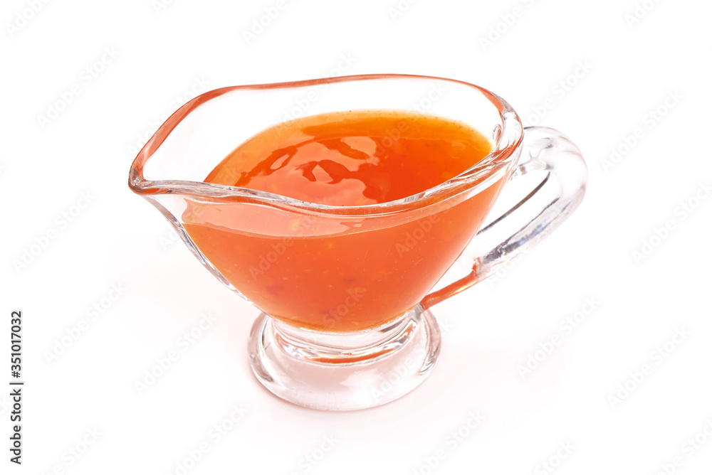 Sweet chili sauce in a gravy boat, isolated on white background Sweet chili sauce in a gravy boat, isolated on white background