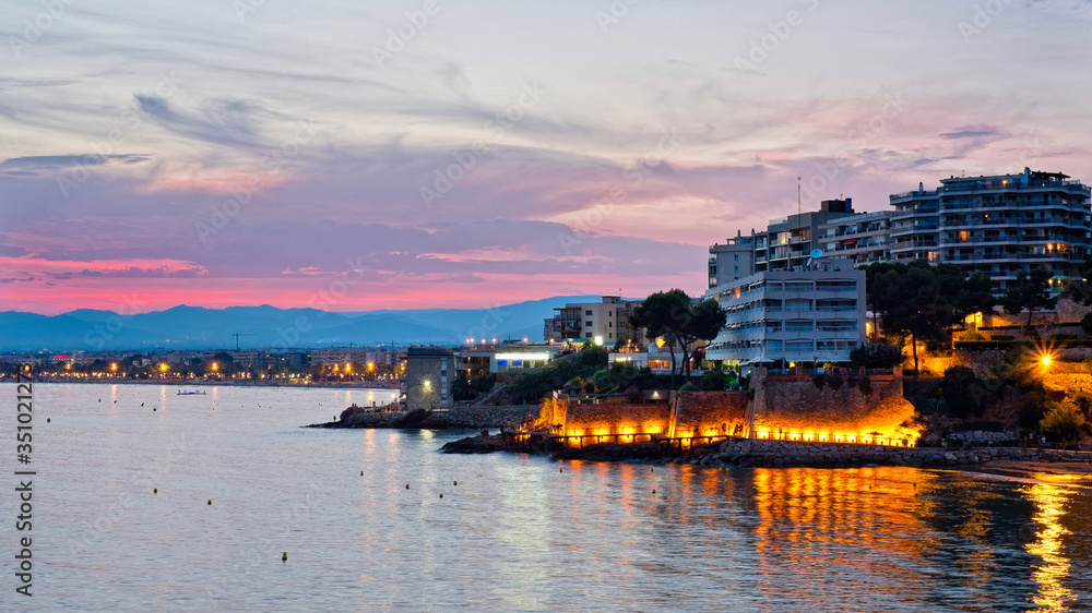 Fototapeta premium Sunset on the sea coast. Spain, Salou. Pink sunset. Night photograph.