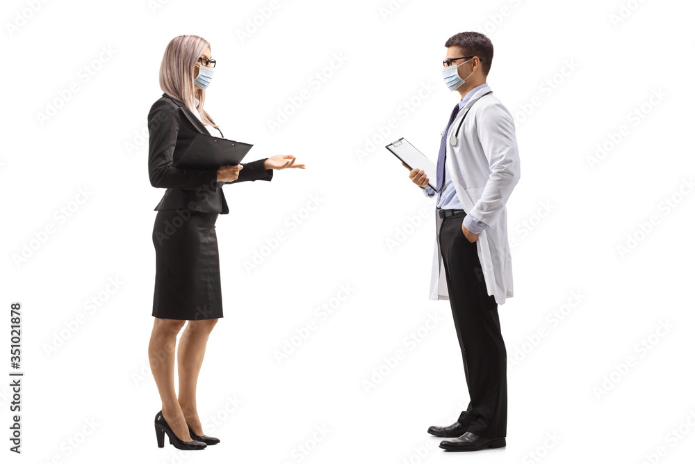 Businesswoman and a male doctor talking and wearing protective masks Businesswoman and a male doctor talking and wearing protective masks
