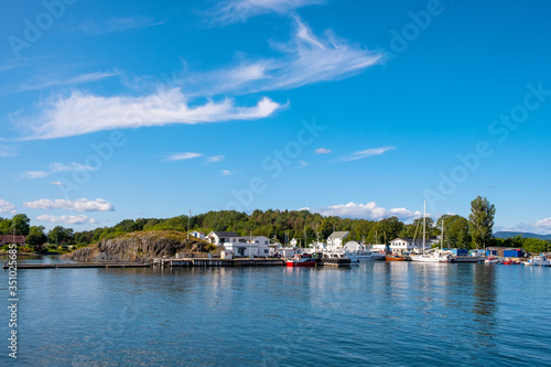 Panoramic view of Lindoya island on Oslofjord harbor near Oslo, Norway, with Lindoya Ost marina and summer cabin houses at shoreline in early autumn