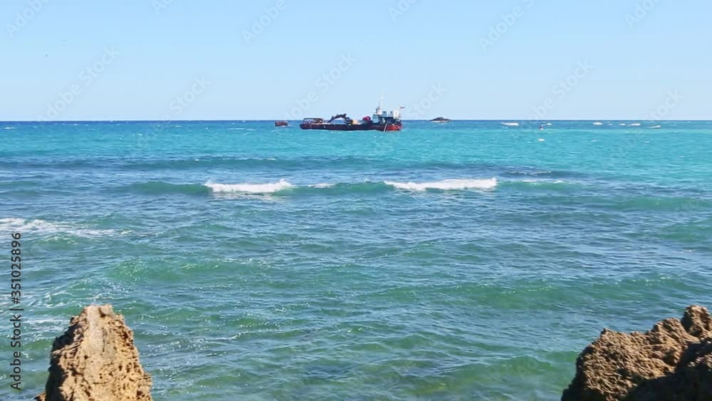 slowly zoom on large black ship surrounded by white waves in endless blue ocean slowly zoom on large black ship surrounded by white waves in endless blue ocean