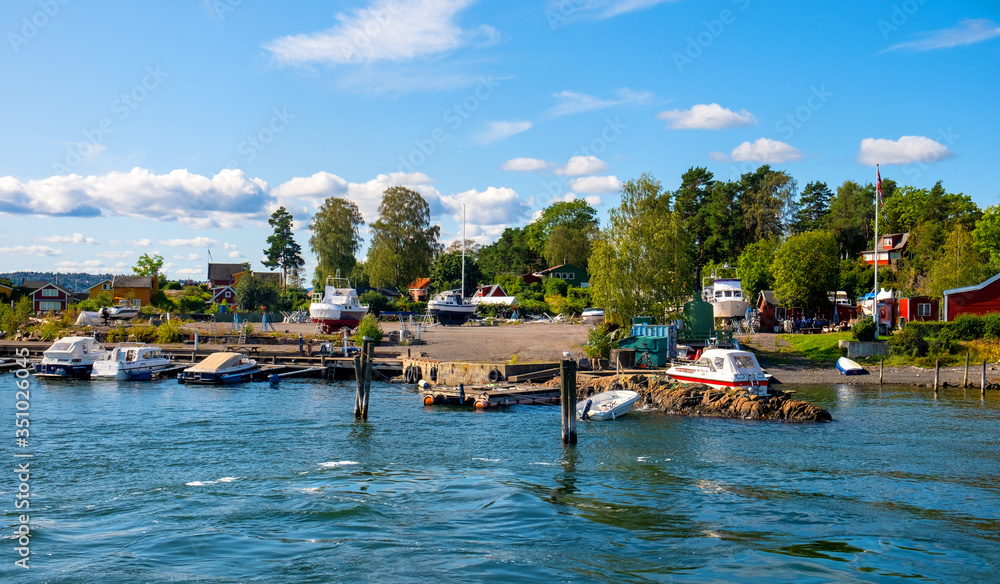 Panoramic view of Lindoya island on Oslofjord harbor near Oslo, Norway, with Lindoya Ost marina and summer cabin houses at shoreline in early autumn Panoramic view of Lindoya island on Oslofjord harbor near Oslo, Norway, with Lindoya Ost marina and summer cabin houses at shoreline in early autumn