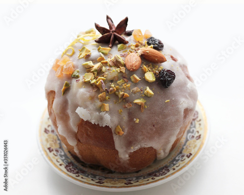 Delicious dessert pie with slices of dried fruit and almonds isolation