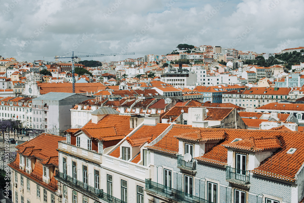 View of the roofs and facades of typical buildings in Lisbon, tiled roofs in Europe. Architecture or travel destination concept