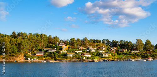 Panoramic view of Lindoya island on Oslofjord harbor near Oslo, Norway, with Lindoya Vest marina and summer cabin houses at shoreline in early autumn
