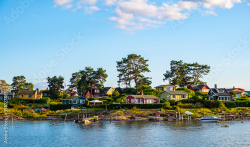 Panoramic view of Nakholmen island on Oslofjord harbor near Oslo, Norway, with summer cabin houses at shoreline in early autumn photo