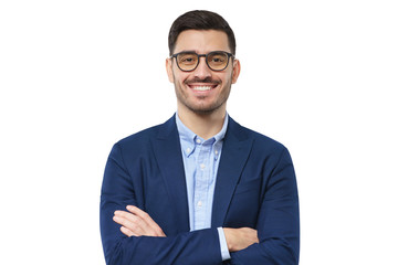 Close-up of young college teacher dressed in blue suit, wearing eyeglasses, looking at viewer with happy smile, arms crossed, isolated on white background
