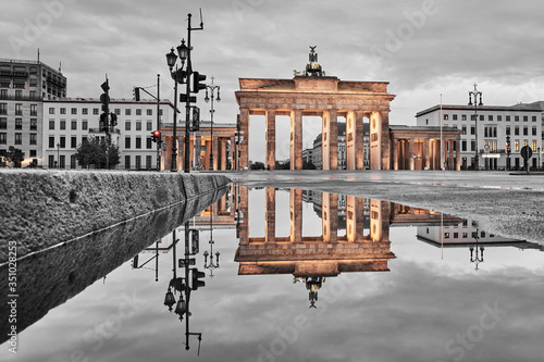 Photography Brandenburg gate after the rain, beautiful reflection of the yellow golden gate