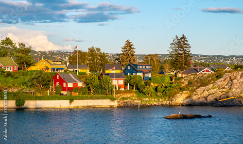 Panoramic view of Nakholmen island on Oslofjord harbor with summer cabin houses at shoreline in early autumn near Oslo, Norway