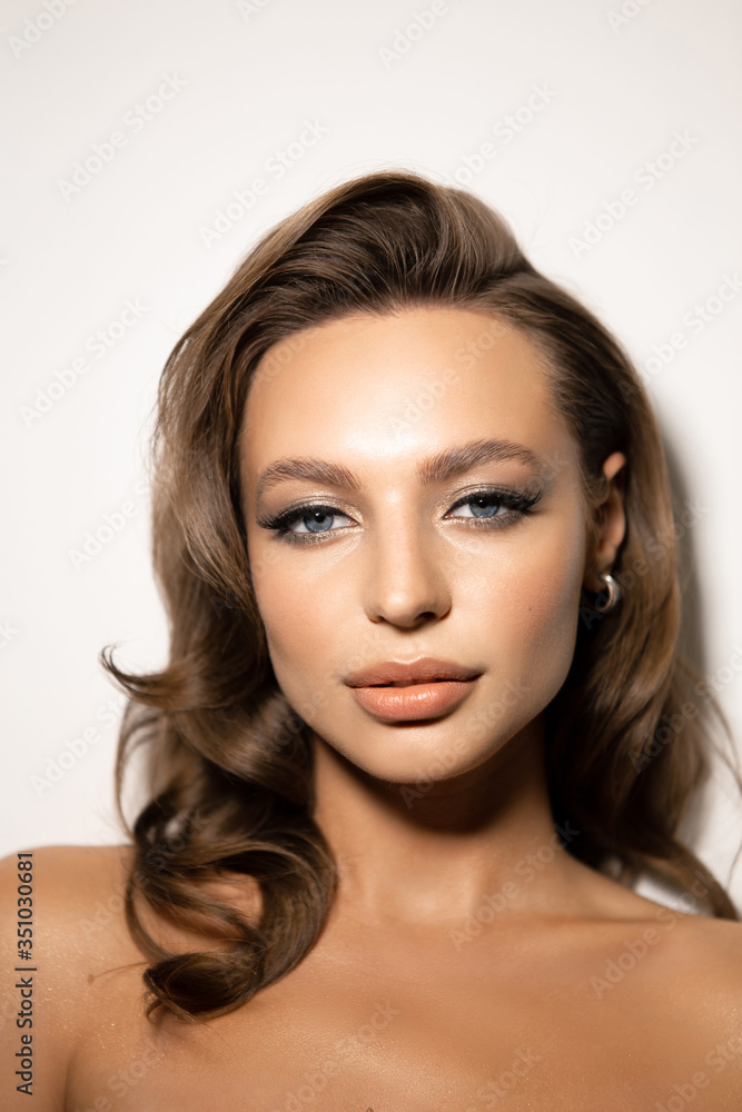 Naklejka premium Portrait of a beautiful woman with makeup and styling. Blue eyes, fashionable eyebrows and beautiful lips.