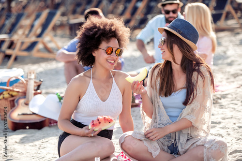 Two woman having fun on the beach. © ivanko80