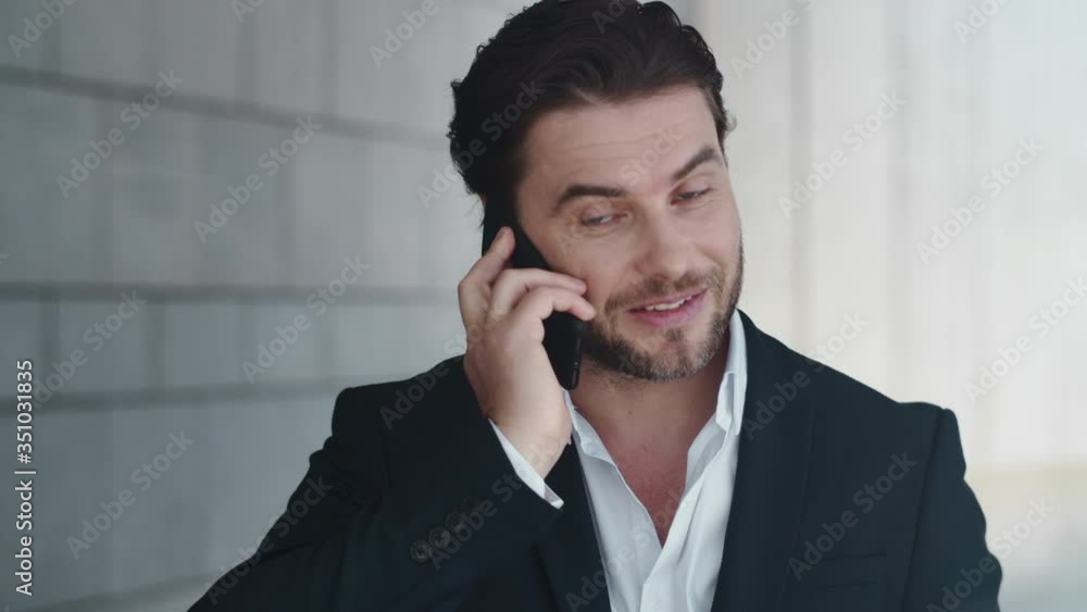 Businessman talking on cellphone on street. Man calling on smartphone in city Businessman talking on cellphone on street. Man calling on smartphone in city