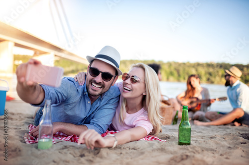 Happy young couple take selfie on the beach