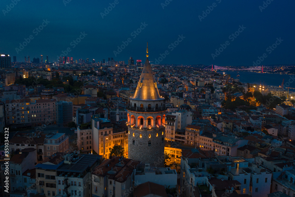Galata Tower night aerial with Bosphorus Bridge on the background