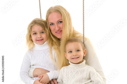 Happy Family of Mother and Two Kids Sitting Together on Rope.