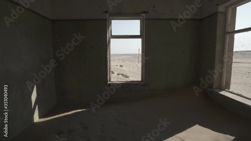 Dessert against sky seen through window of abandoned house - Kolmanskop, Namibia photo