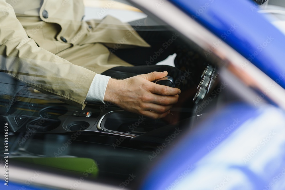 Male hand on the shift lever of the transmission in the car Male hand on the shift lever of the transmission in the car