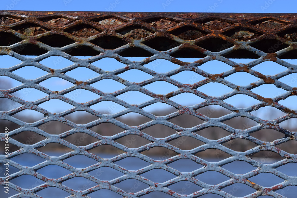 A rusty old fence overlooks a lake A rusty old fence overlooks a lake