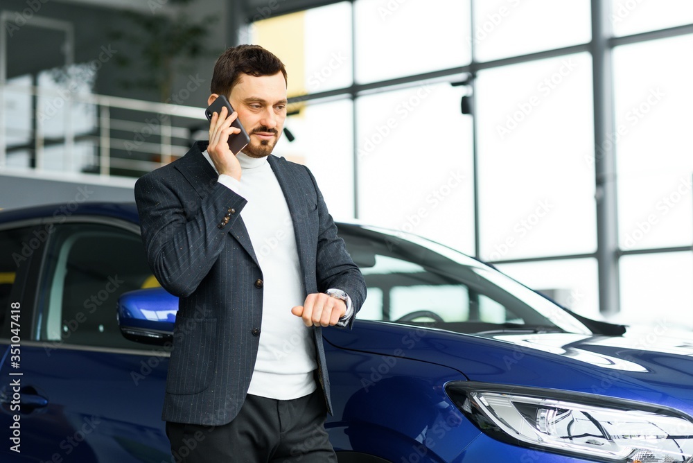 business, car sale, consumerism and people concept - happy man over auto show or salon background business, car sale, consumerism and people concept - happy man over auto show or salon background