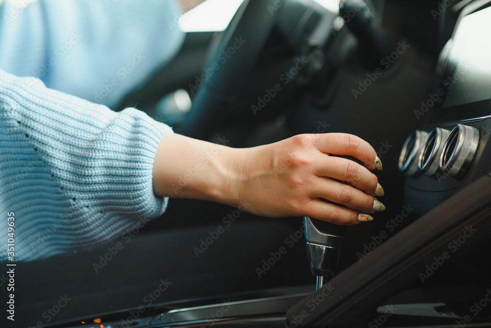 woman's hand speed switches in the vehicle while driving