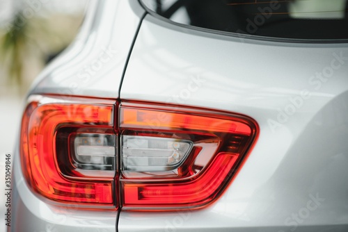 Back view of new white car. Closeup headlights of car. White premium city crossover  luxury SUV rear light closeup. Car lamp close-up.