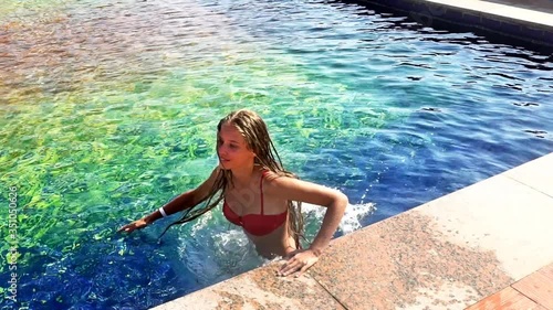 Slow motion of summer season for girl sitting on pool side, fall and swimming green water.
