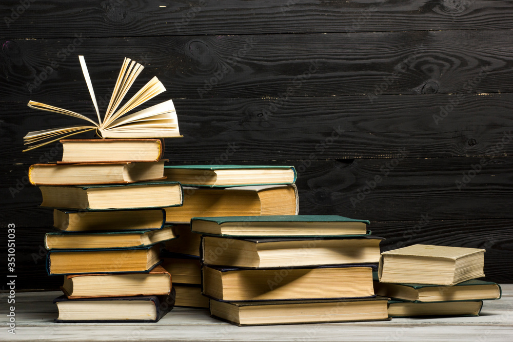Open book, hardback books on wooden table. Back to school. Copy space. Open book, hardback books on wooden table. Back to school. Copy space.