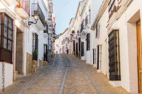Narrow and cozy street in a white village in Andalusia  Spain.