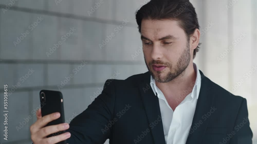 Businessman talking online on street. Man with cellphone working outdoors Businessman talking online on street. Man with cellphone working outdoors