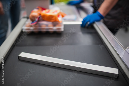cash desk line. the seller is wearing rubber gloves. concept with copyspace. close up
