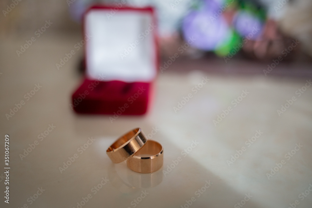 Golden rings in the background a red casket. Wedding day. Golden rings in the background a red casket. Wedding day.