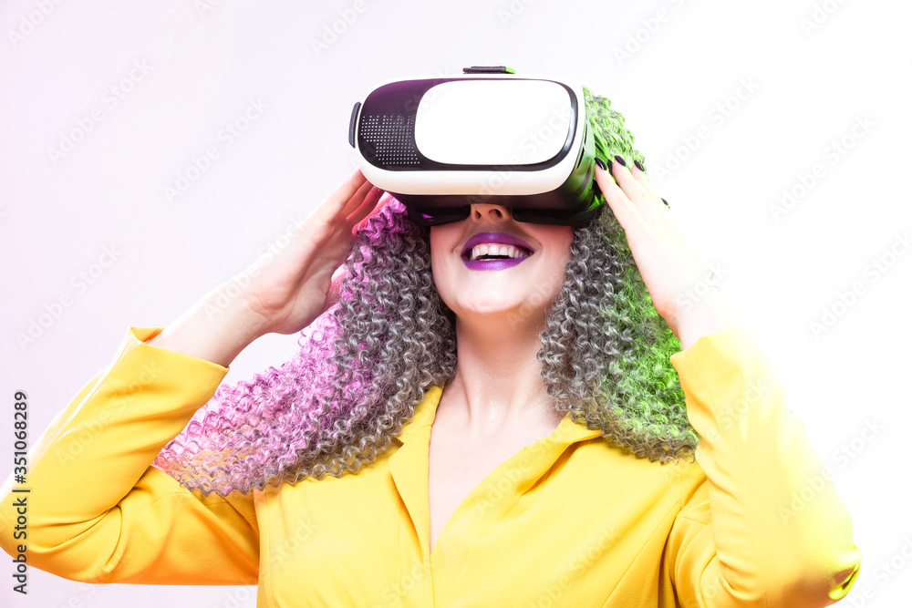 Portrait of caucasian Girl With Curly Colorful Hair Playing With VR (Virtual Reality) Helmet.