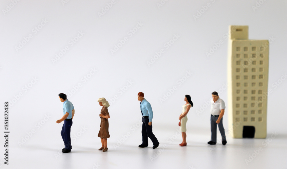 Miniature people walking out of miniature buildings.
Miniature people walking out of miniature buildings.