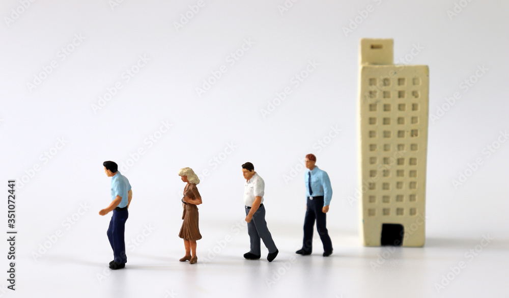 Miniature people walking out of miniature buildings.
Miniature people walking out of miniature buildings.